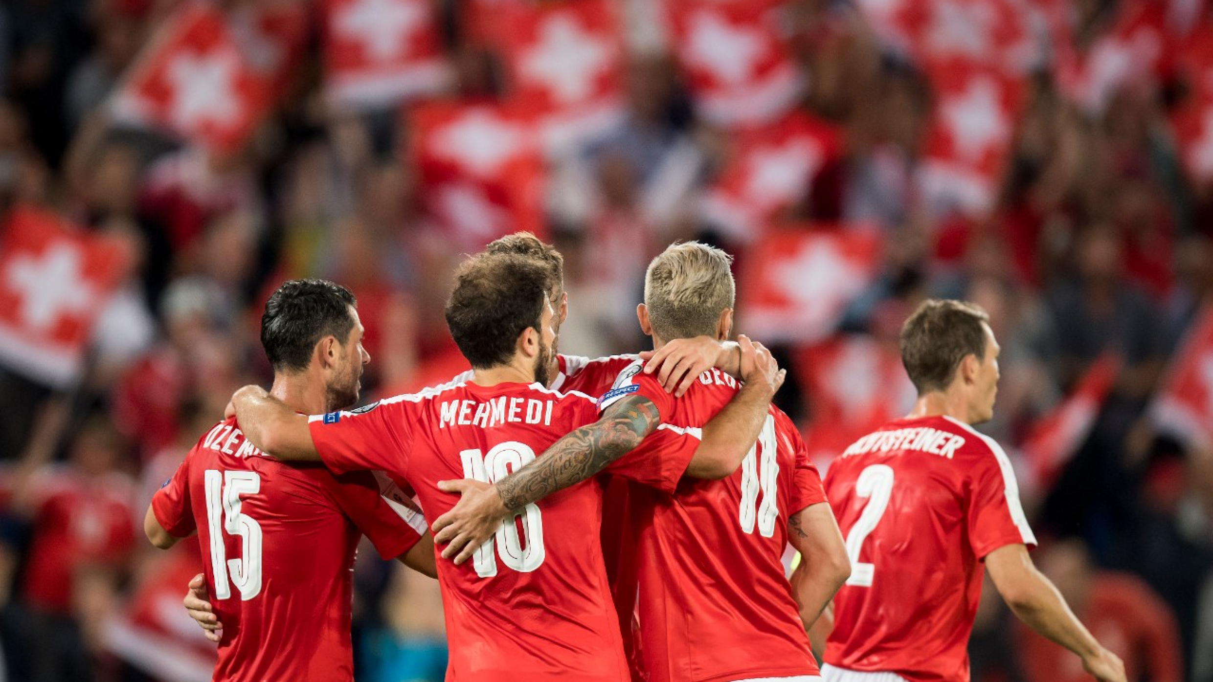 Swiss soccer players with Swiss midfielder Admir Mehmedi, center, celebrates after the second goal during the 2018 Fifa World Cup Russia group B qualification soccer match between Switzerland and Portugal at the St. Jakob-Park stadium, in Basel, Switzerland, Tuesday, September 6, 2016. (KEYSTONE/Jean-Christophe Bott)
