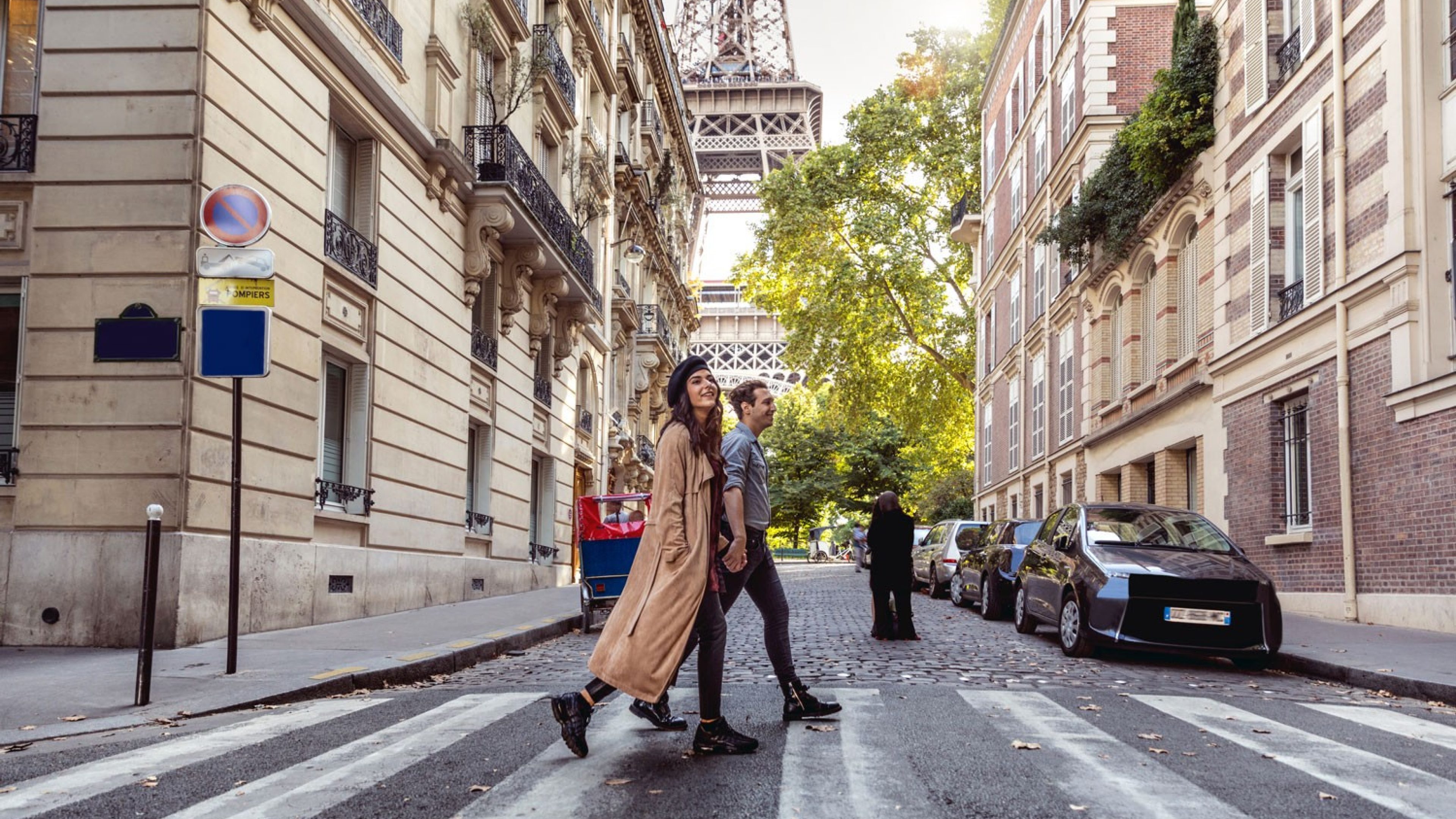 Ein Paar läuft Hand in Hand durch Paris.