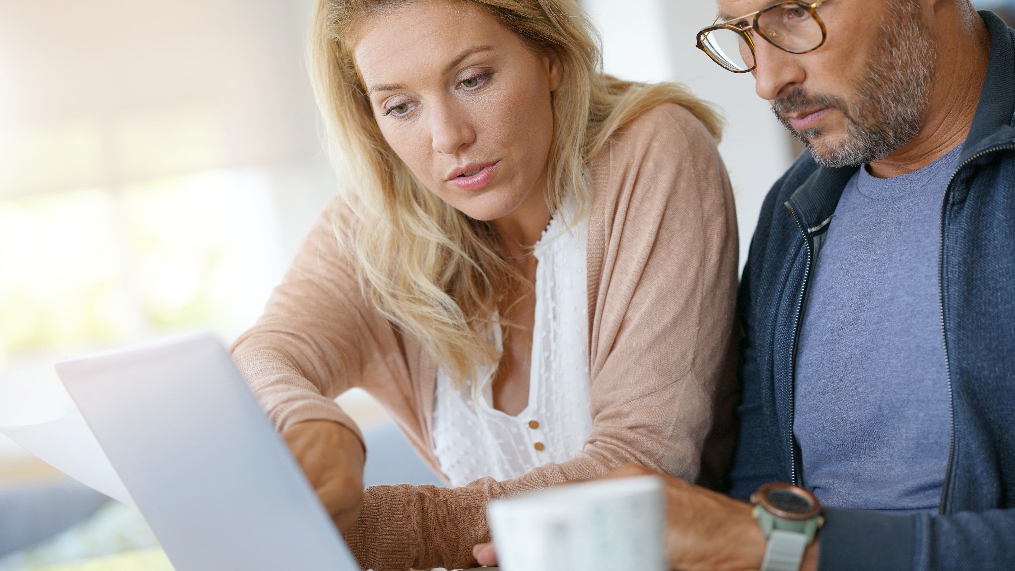 Mature couple at home working on laptop computer