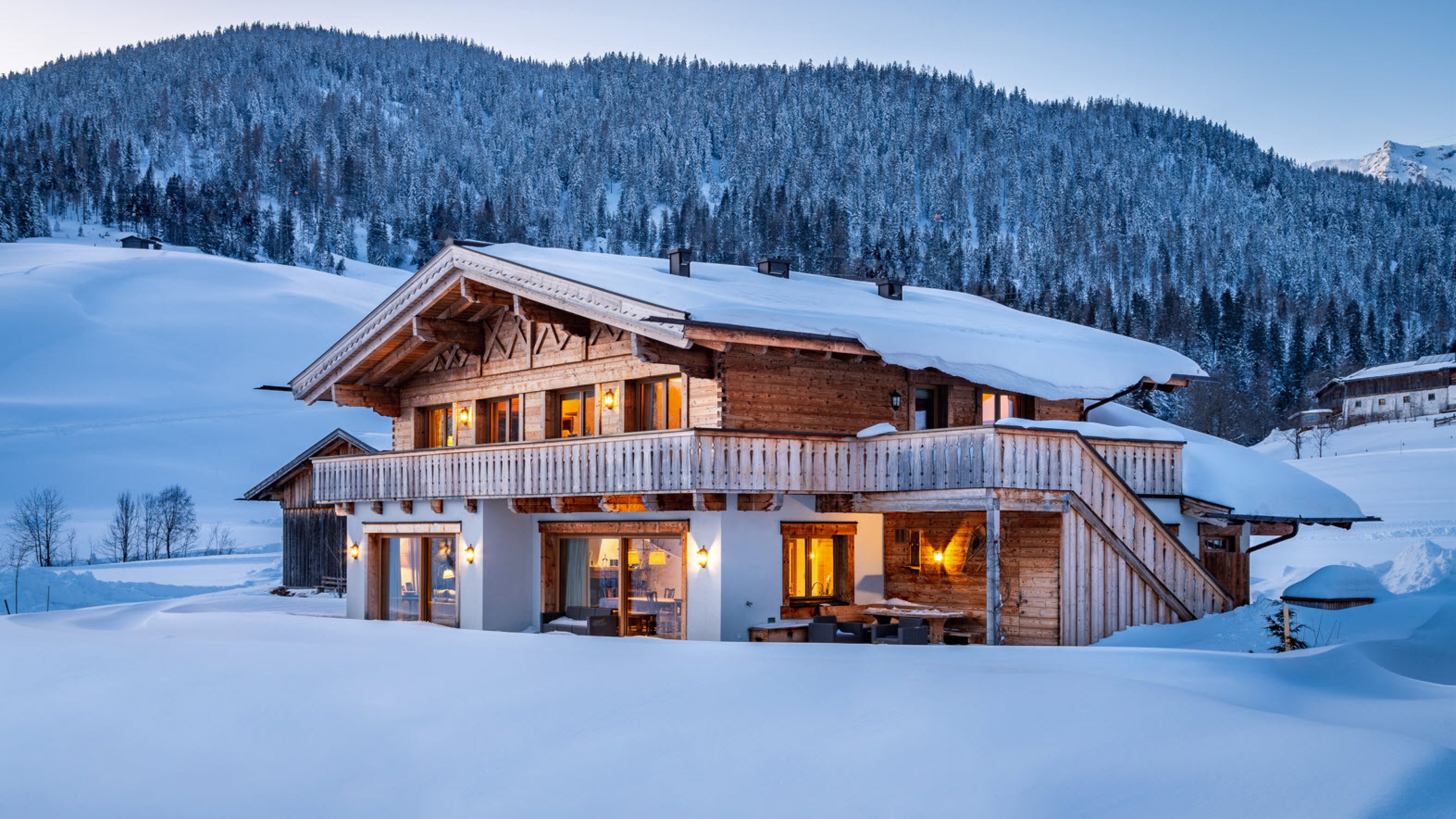 Grosses Holzchalet in den Bergen an einem kalten Winterabend