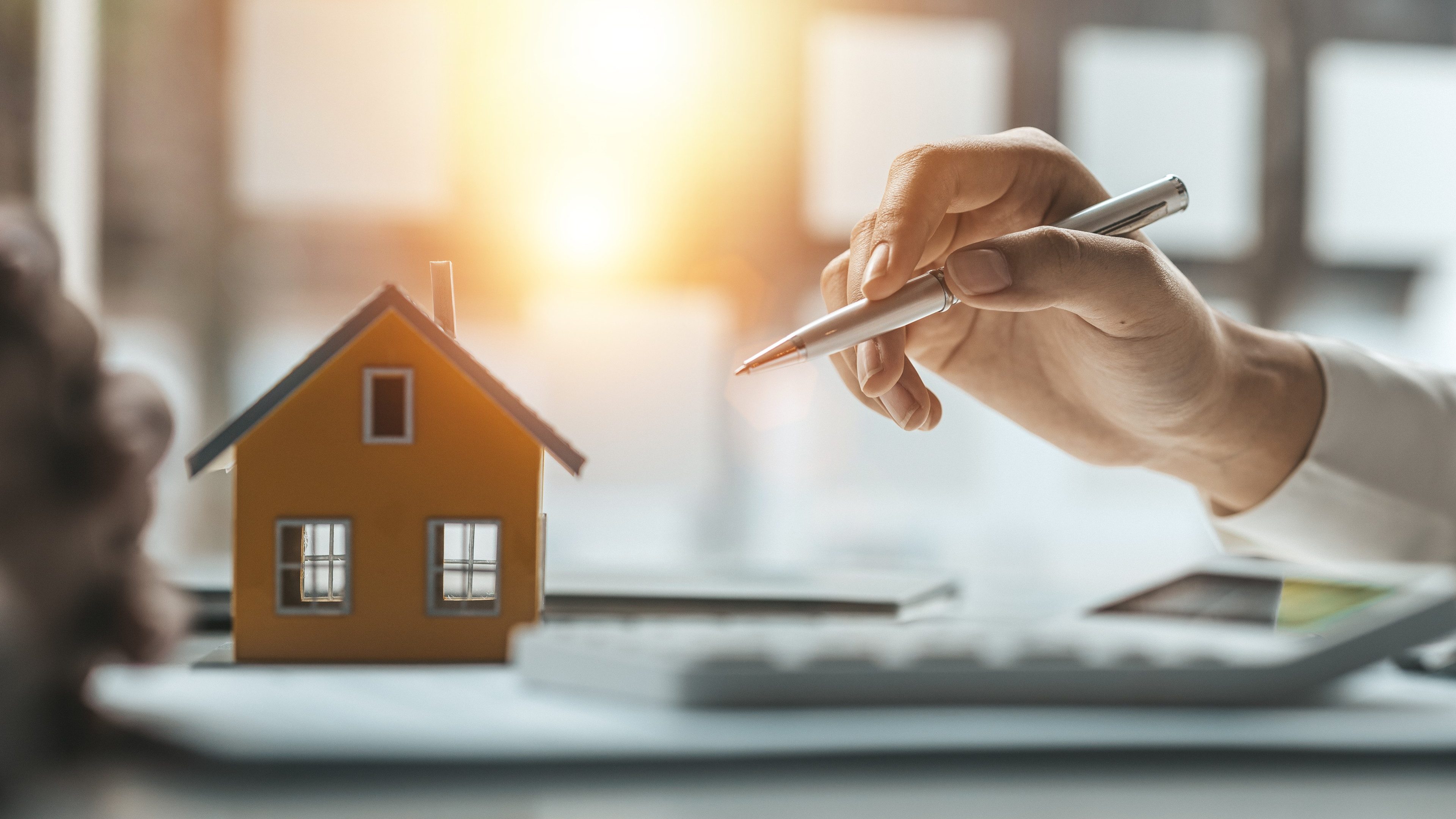 Real estate agents explain models of housing estates in projects to elaborate to clients, explaining and presenting information about homes and purchasing loans. Real estate trading concept.