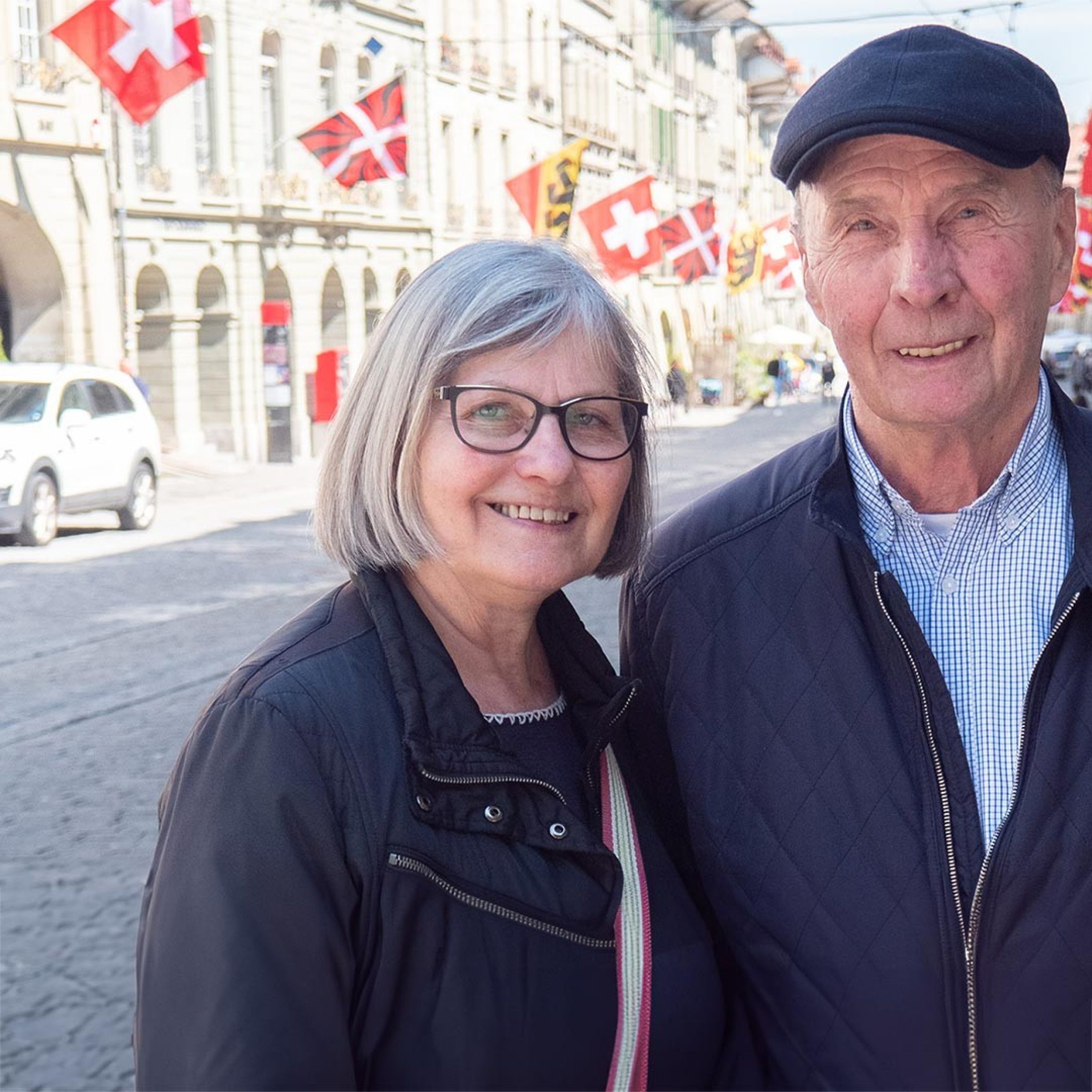 Älteres Ehepaar lächelt in Kamera in Berner Innenstadt