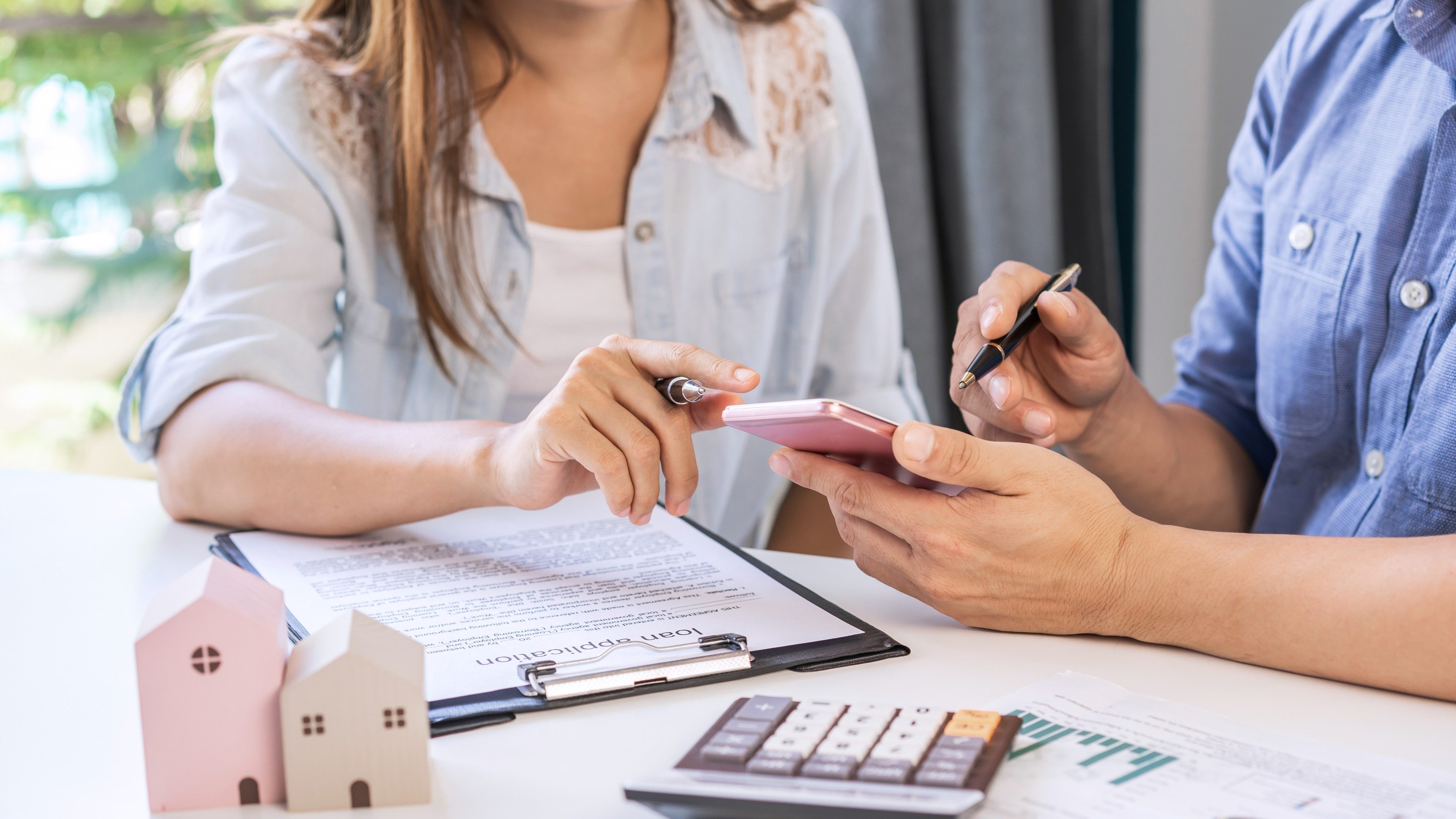 Young couple planning and looking for comparison information on their decision to buy a new home together