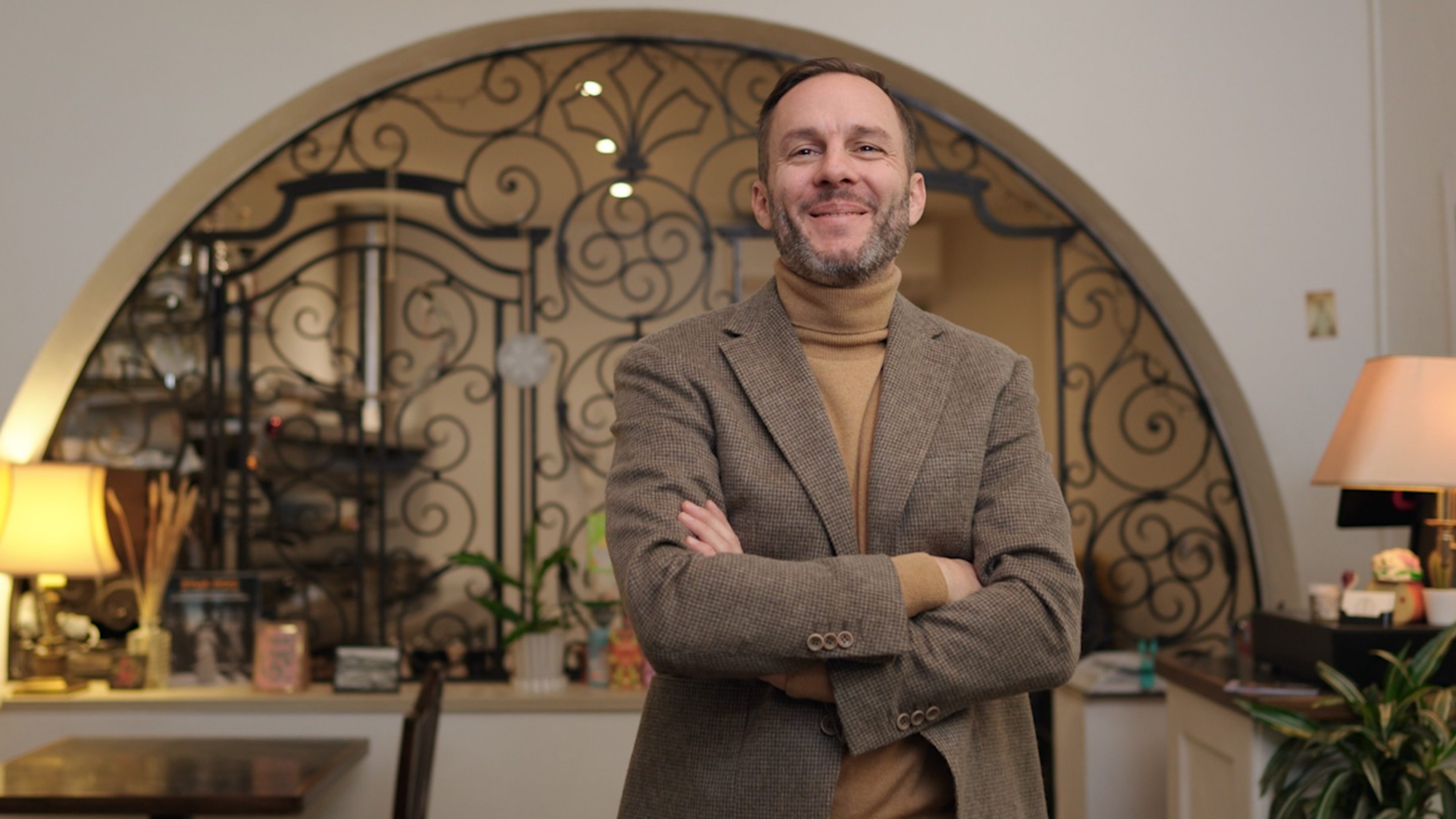 Man in business outfit smiles at the camera