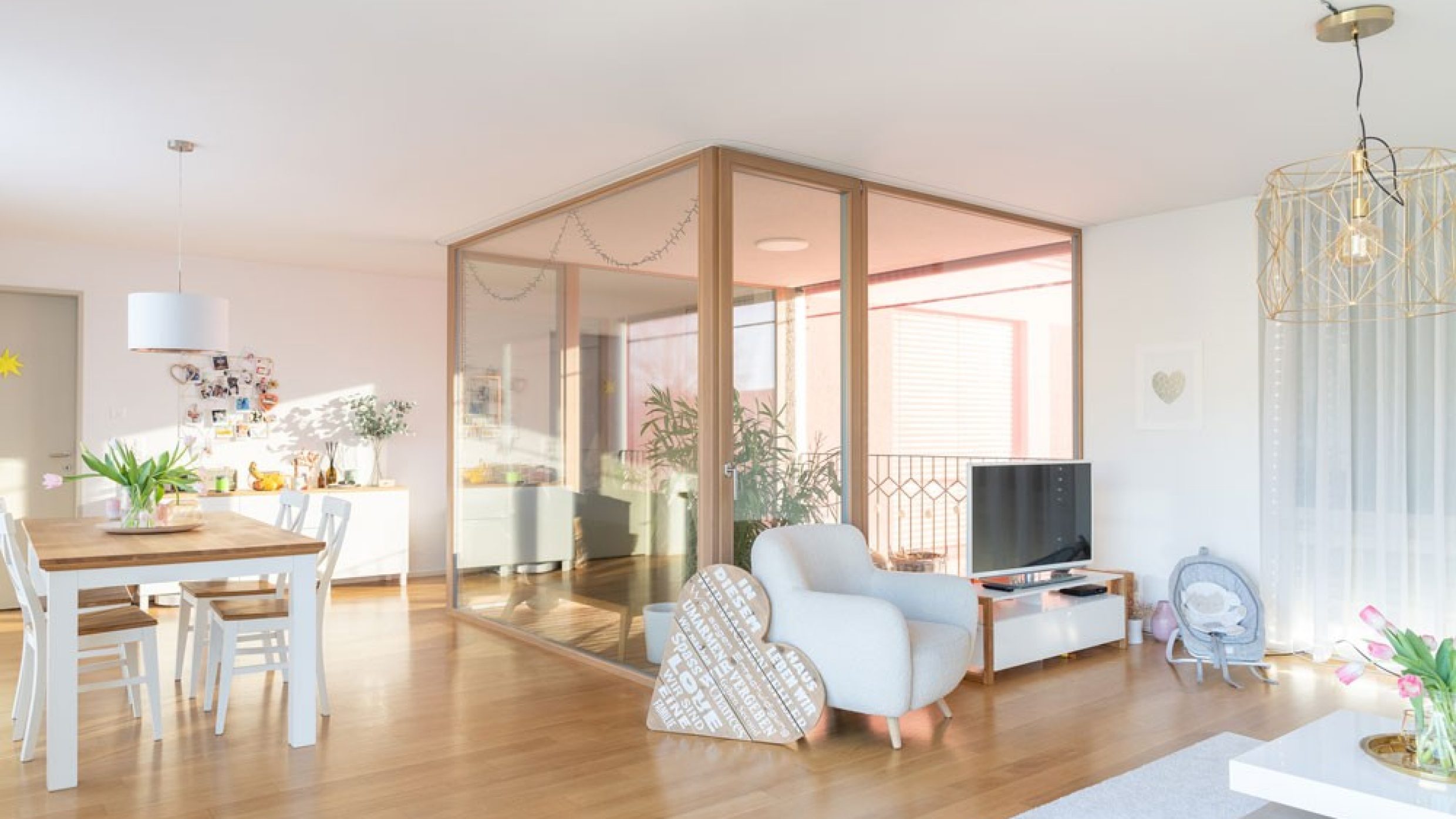 Floor-to-ceiling windows line a loggia that sits like a glass cube in the living room.