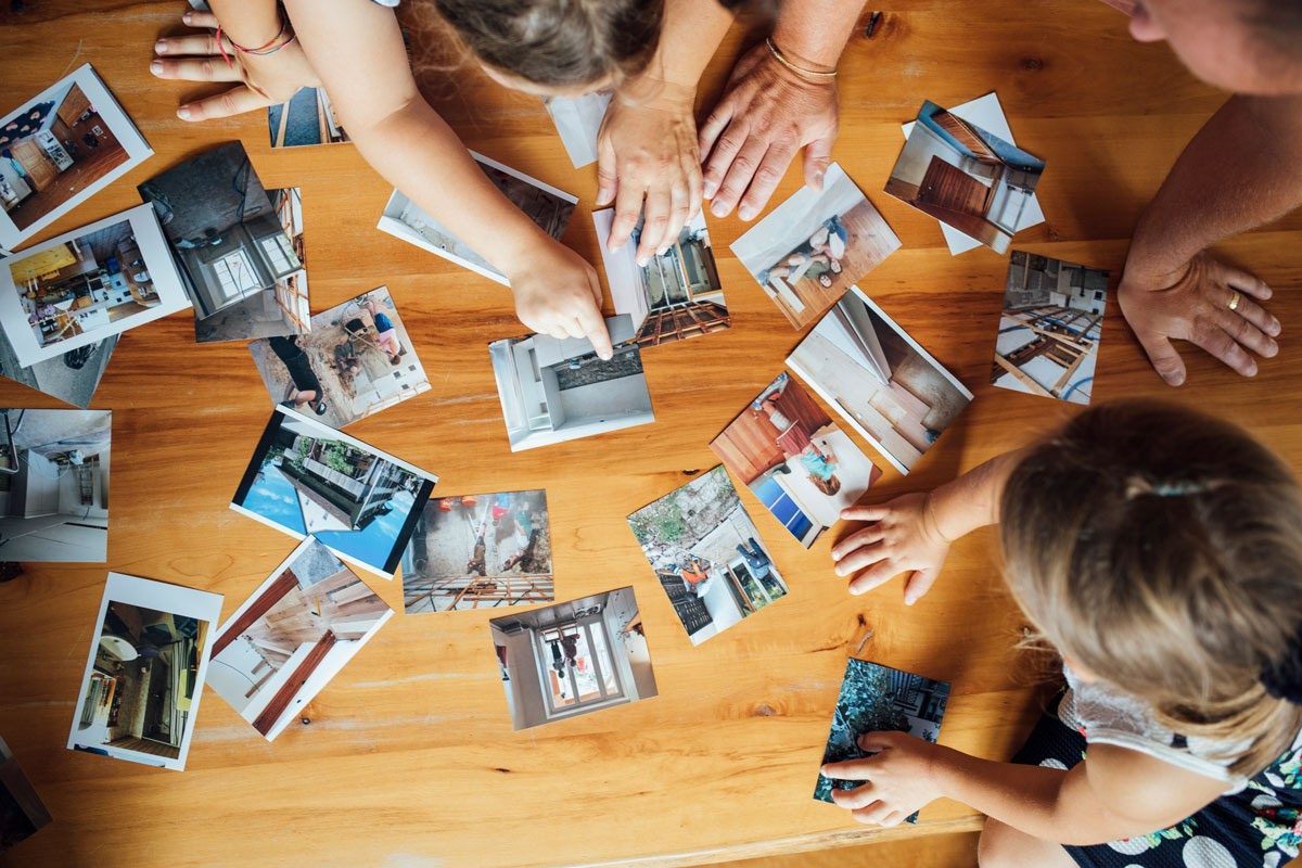 Family looks at pictures of house renovations.