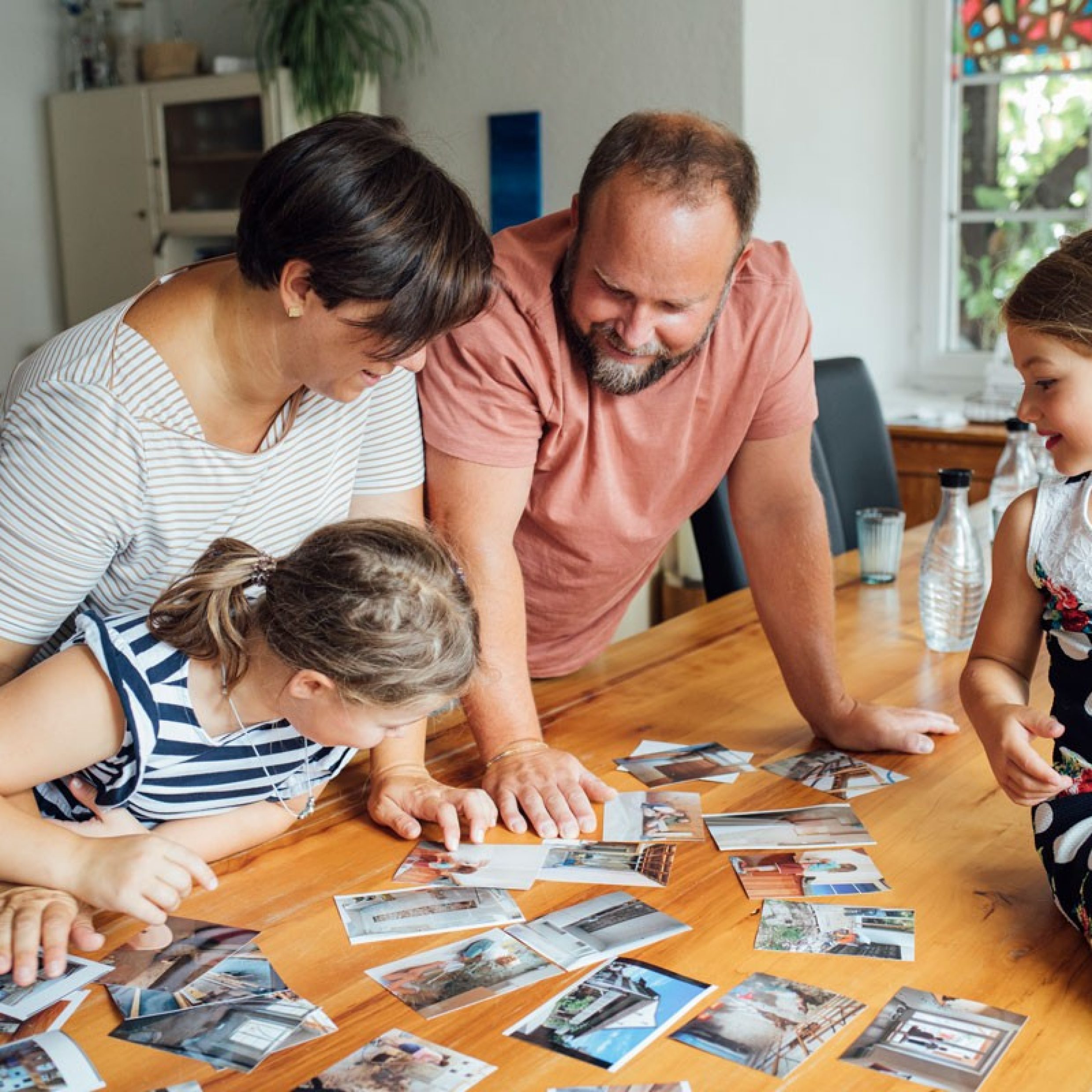 Family looks at pictures of house renovations.