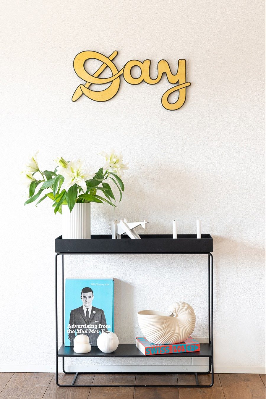 The "Day" lettering hangs above a simple sideboard.