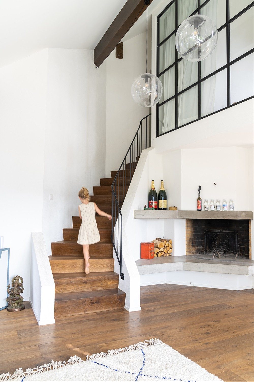 One of the Days’ children skips up the stairs beside the fireplace.