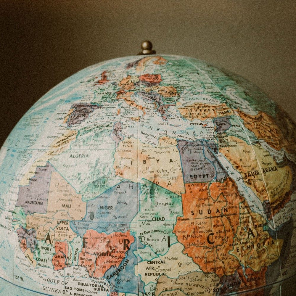 The northern half of a globe with the countries in colour, showing the continent of Africa in front.