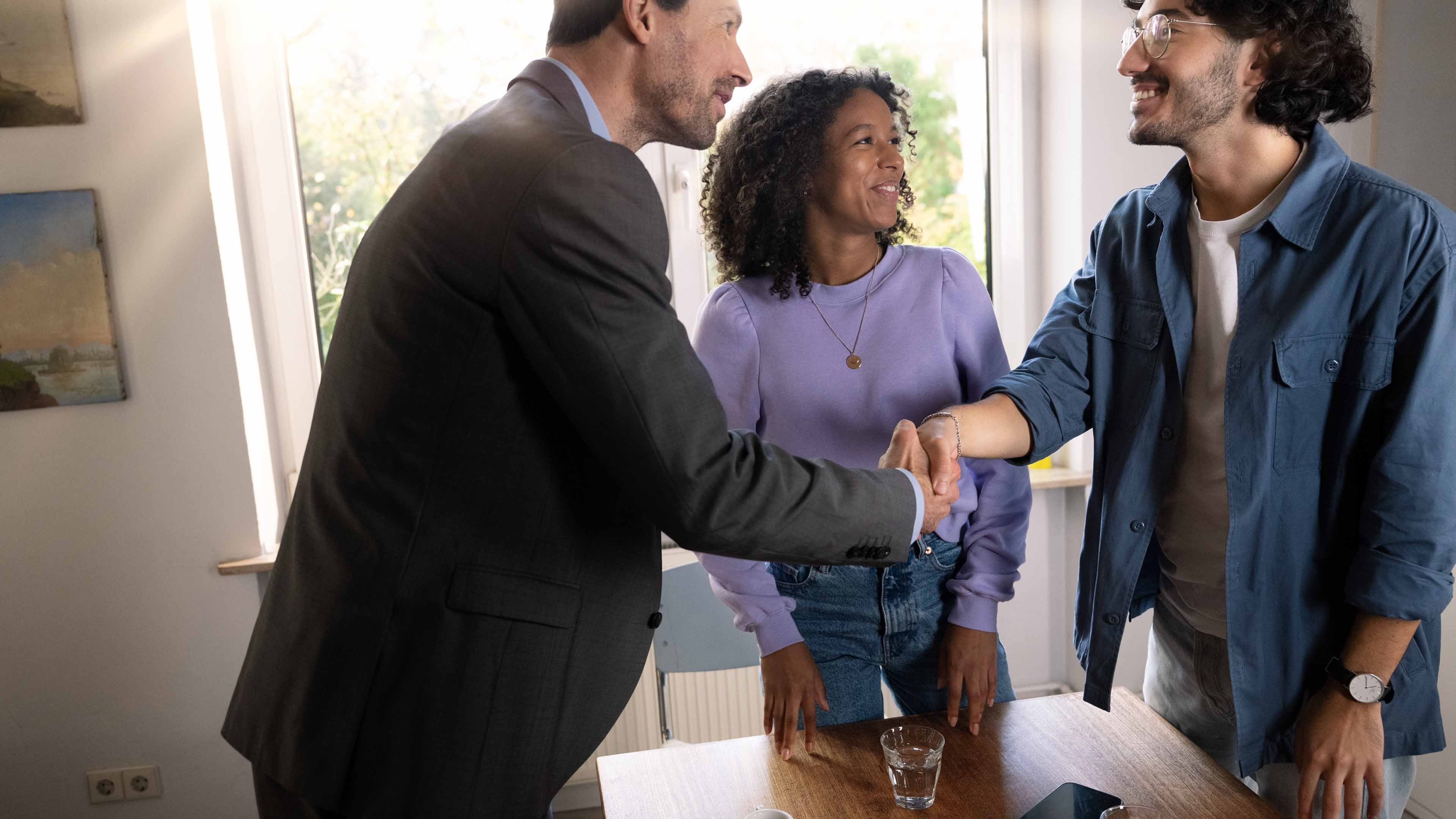 A young woman, a young man and  their pensions advisor