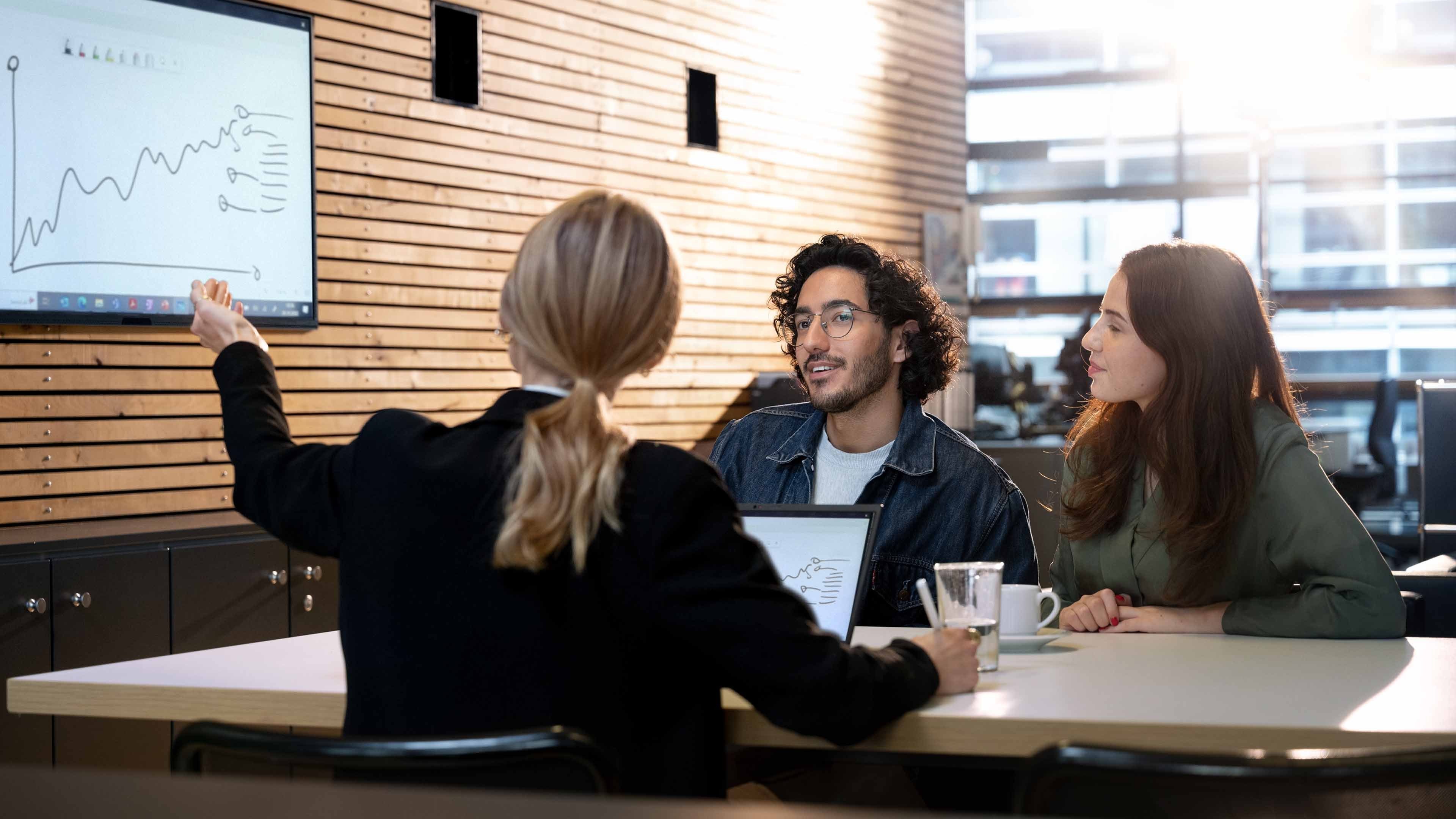 A young woman and a young man talking to a pensions advisor