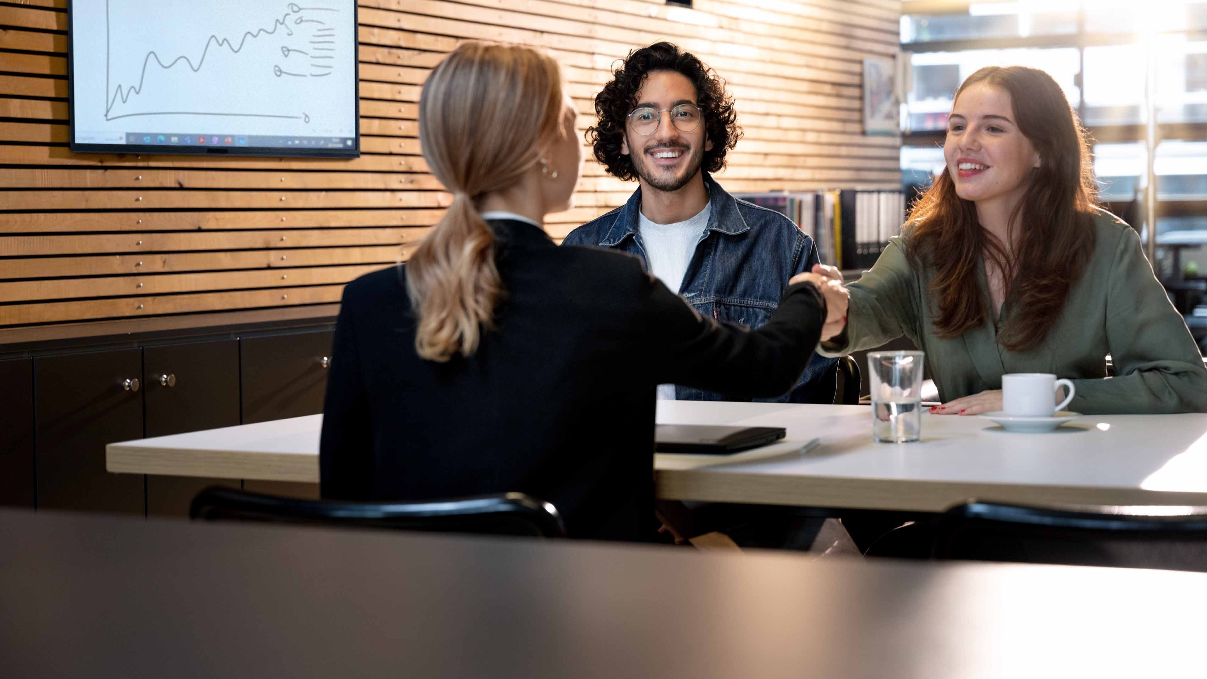 A young man, a young woman and their their pensions advisor