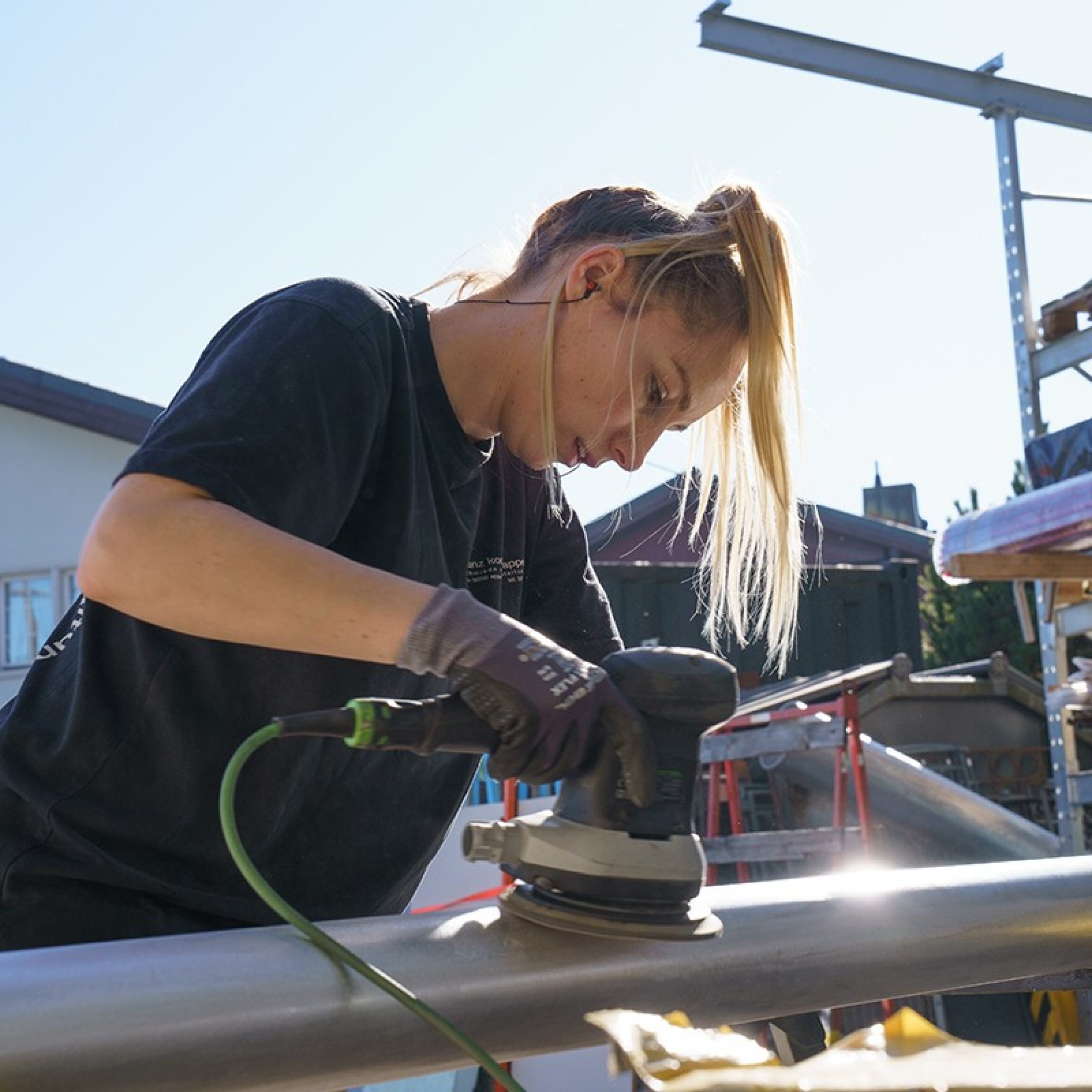 A woman working with a grinding machine. 