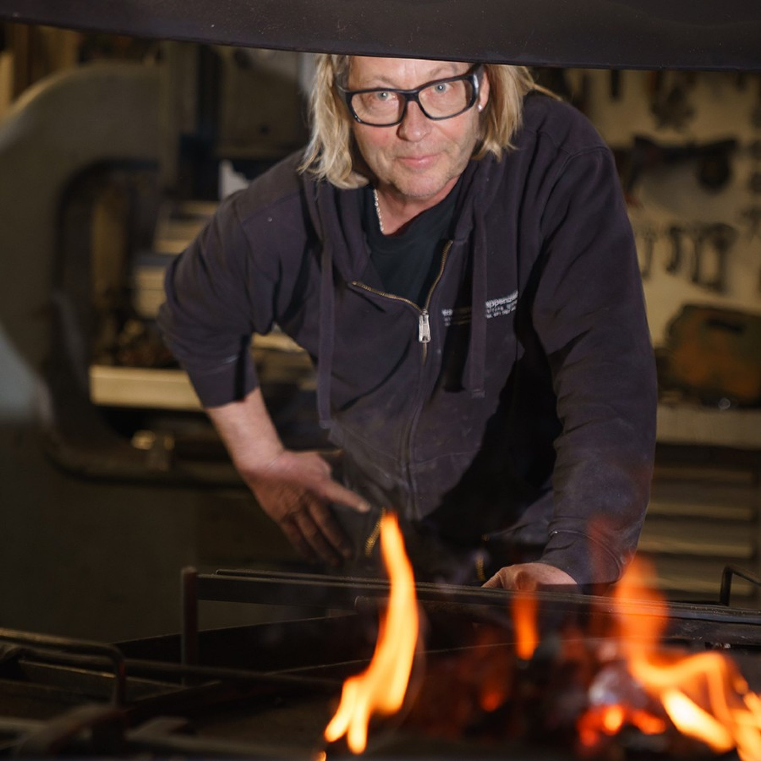 A man standing in a forge.