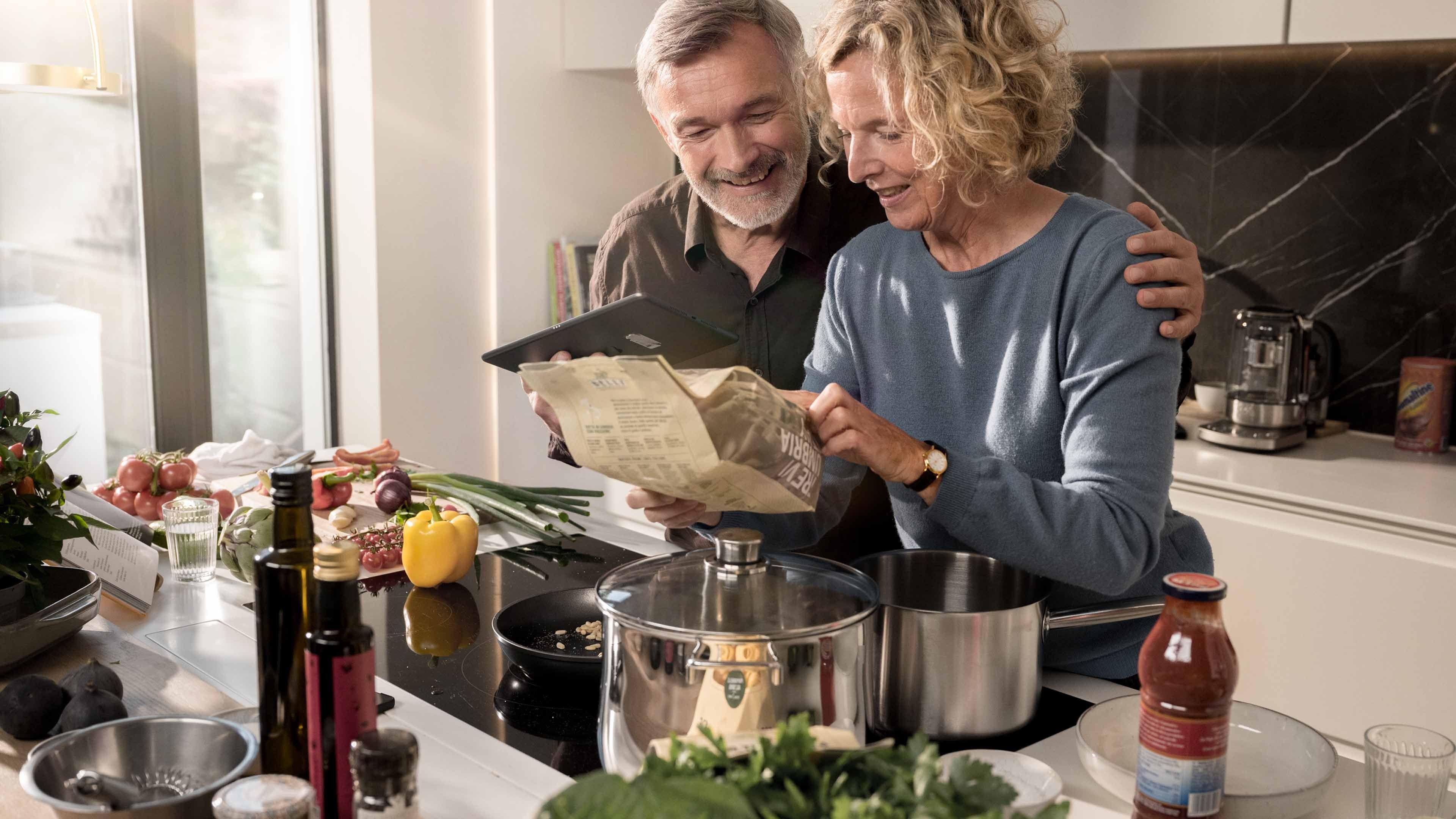 Une femme et un homme préparent le repas du soir.