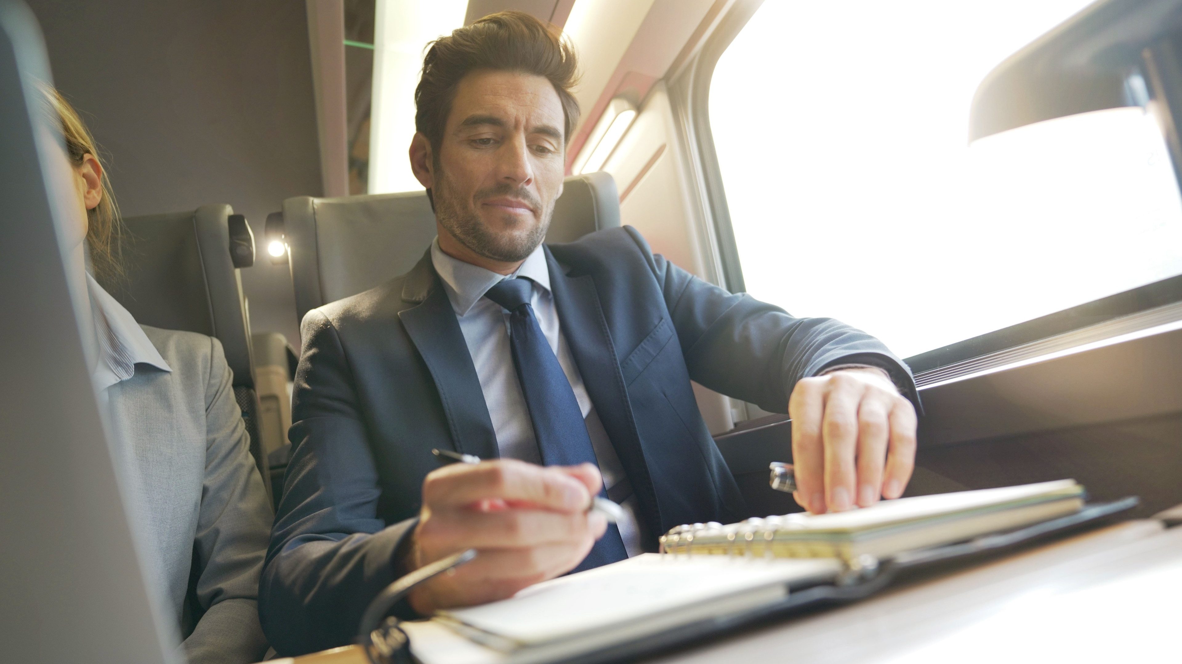businessman working on a train in business class