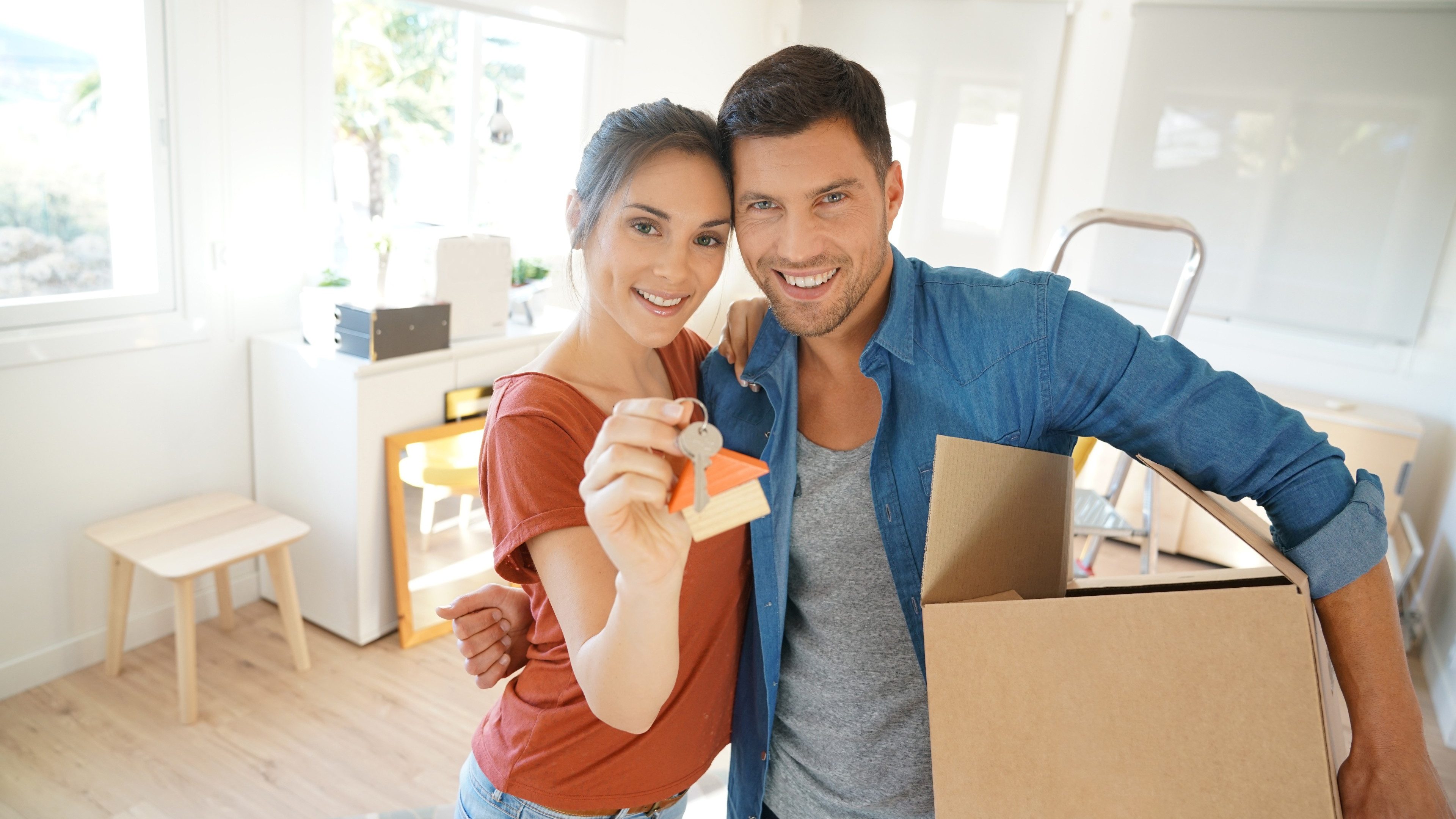 Happy couple showing keys of new home