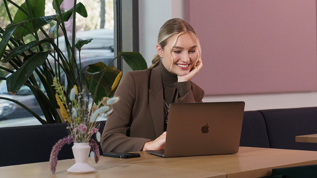 Manuela Frey siede in un caffè con un laptop.